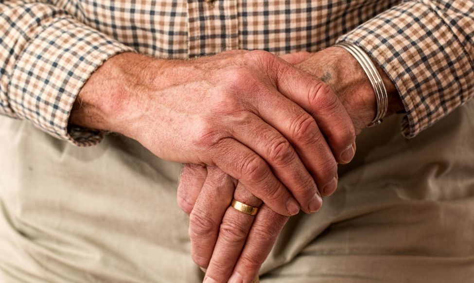 Elderly Hands holding Cane